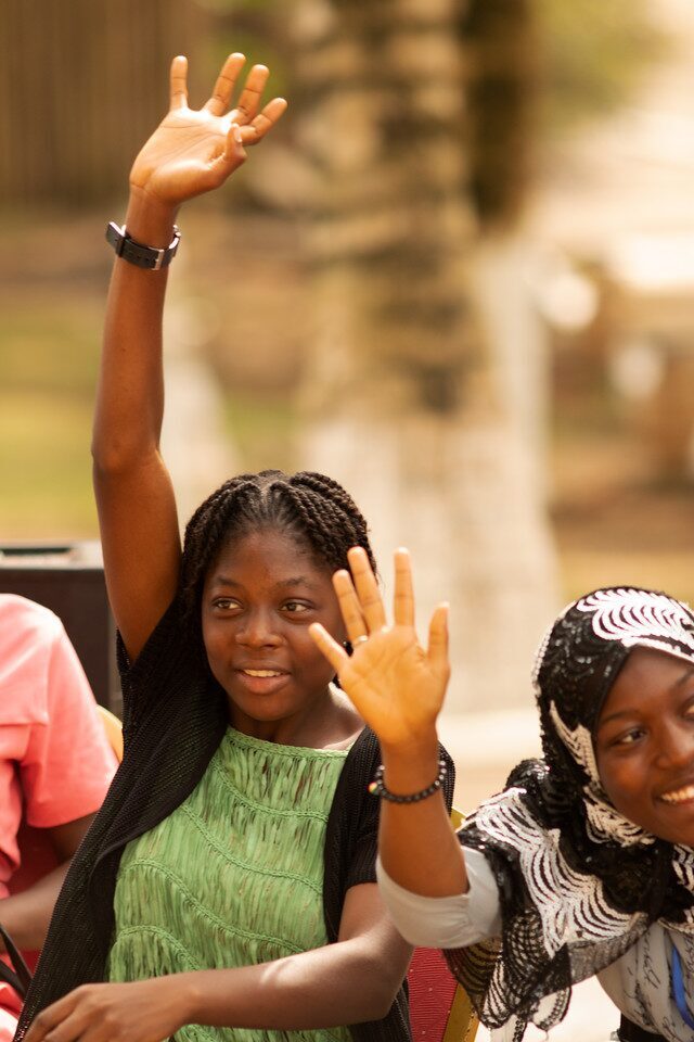 Girls raising hands